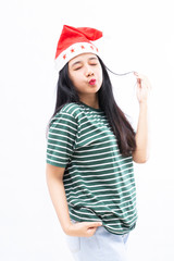 Fototapeta premium portrait of a young asian woman wearing a santa hat with a white isolated background