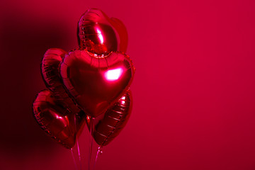 Celebrating Saint Valentine's Day with heart shaped red foil air balloon. Gift for loved woman on...