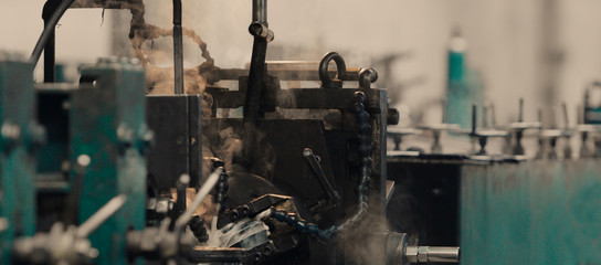 Fototapeta premium Industrial metal sheet coils connected with metal sheet profile forming machine