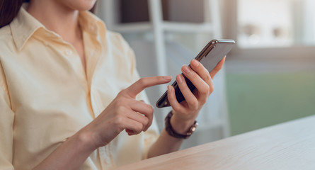 Woman hand hold smartphone and reading messages on the social.