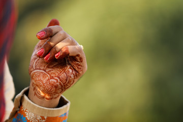 Beautiful Indian bride hand with mehandi design and jewelry 