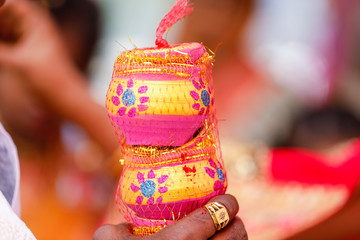 Traditional indian wedding ceremony in Hinduism :decorative pitchers in hand  