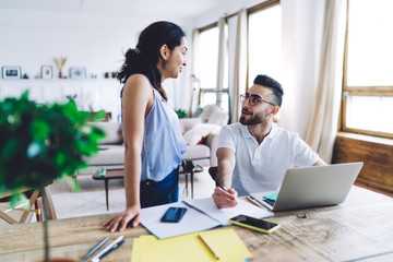 Fototapeta premium Male handsome freelancer talking with girlfriend working at home office