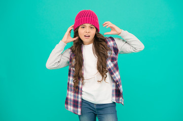 Modern fashion. How cool am I. Kids fashion. Girl cute child wear knitted hat. Little girl wearing winter hat. Comfy and cool. Girl long curly hair wear hat. Must have street style accessory trends