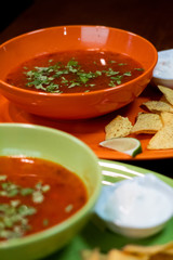 hot tasty delicious rustic homemade american pizza with tomato gherkin salami olives with thick crust on black table