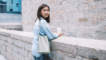 Modern Asian laidback casual woman relaxing on street