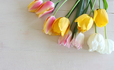 Bouquet of tulips over wooden table. Spring greeting card happy mother day copy space.