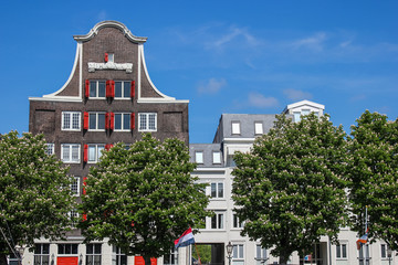 Wolwevers harbour facades of Dutch storage houses on a clear blue sky day, Dordrecht, The Netherlands