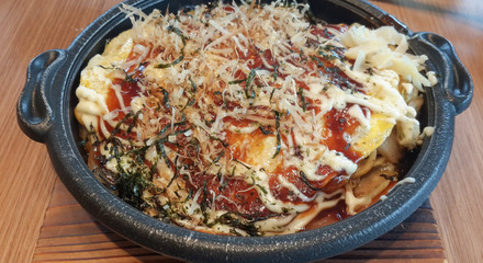 Japanese pizza (Okonomiyaki) in the hot plate