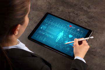 Business woman making healthy analysis on tablet