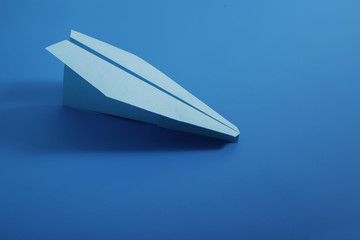 Paper plane on blue color background.  Color of  year 2020 Classic Blue pantone