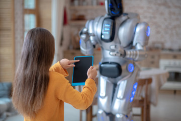 Long-haired girl holding a tablet in her hands
