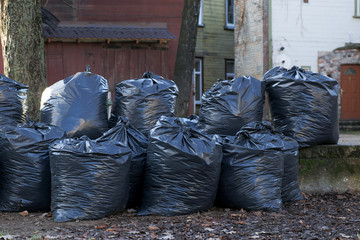 Black plastic bags with trashes