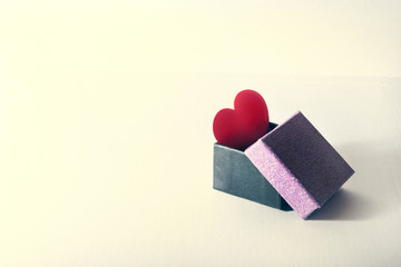red heart in a gift box on a white background..