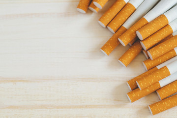image of several commercially made pile cigarette on white wooden background. or Non smoking...