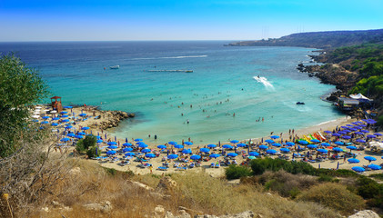 Fototapeta premium People at the famous beach of Konnos Bay Beach, Ayia Napa. Famagusta District, Cyprus. Best beaches of Cyprus - Konnos Bay in Cape Greko national park