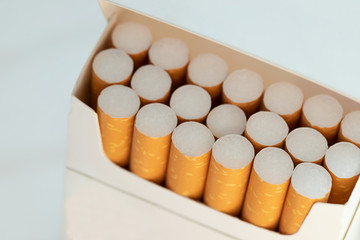 peel it off Cigarette pack prepare smoking on white wooden background. Packing line up.  photo filters Natural light.