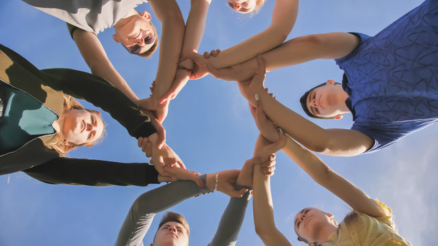 Partnership and unity concept: people holding wrists of each other