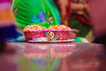 Holding puja thali and oil lamp in hand