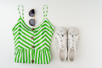 Flat lay of woman summer outfit on white background