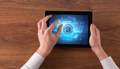 Hand working on tablet with cryptocurrency and network concept