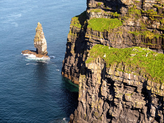 Tooth like stone rock at a bottom of Cliff of Moher, county Clare, Ireland. Sunny day, Cliff...