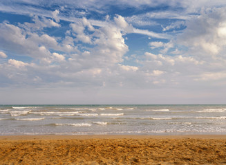 sea ocean on a background of blue sky with clouds