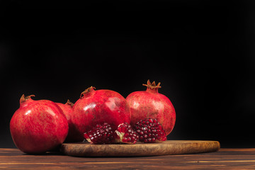 Ripe pomegranate fruit on wooden vintage background. - Image