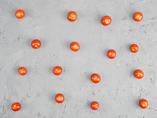Small tomatoes on a gray concrete background. Healthy eating concept