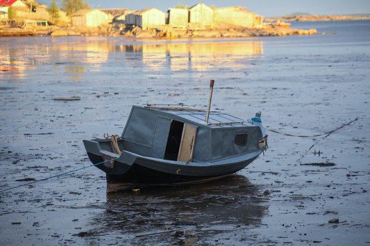 The boat is at sea during low tide