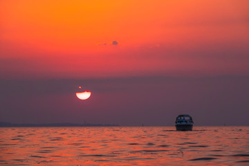 Purple sunset over a sea, boat