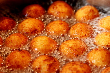 Cottage cheese balls. Small balls of freshly baked homemade cottage cheese fried hot oil. Freshly made donuts from cottage cheese