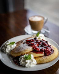 Pancakes with berries and coffee