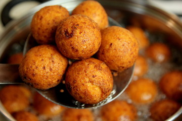 Cottage cheese balls. Small balls of freshly baked homemade cottage cheese fried hot oil. Freshly made donuts from cottage cheese