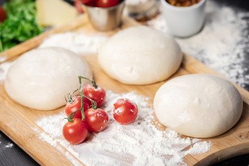 Pizza dough and raw ingredients.