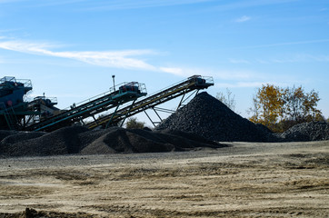 Fototapeta premium Mobile Stone crusher machine by the construction site or mining quarry for crushing old concrete slabs into gravel and subsequent cement production