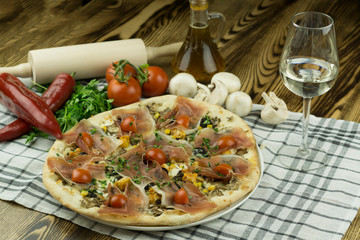 Declicious pizza with ingredients on the side, backed in traditional wooden oven.