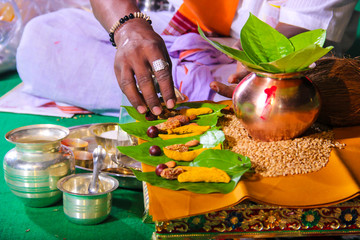 Indian wedding ceremony : decorative coper kalash with green leaf and coconut 
