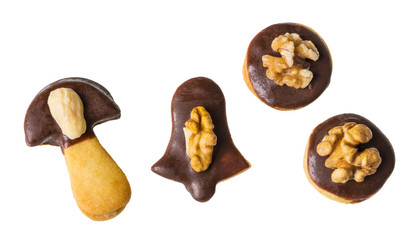 Four shortbread linzer cookies decorated by chocolate glaze and walnuts. Isolated on white. Traditional Czech Xmas and wedding biscuits pasted with nutty spread or jam. Round, mushroom or bell shaped.