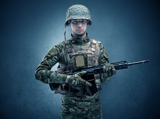 Soldier agent in a dark room with arms on his hand and gas mask