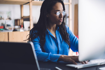 Serious woman typing on keyboard