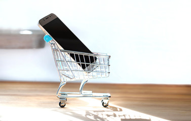 Shopping cart with phones. Online shop for smartphones or internet web store concept