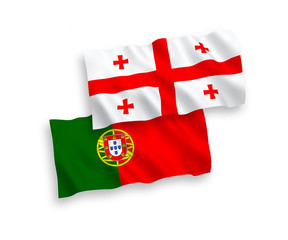Naklejka premium National vector fabric wave flags of Portugal and Georgia isolated on white background. 1 to 2 proportion.