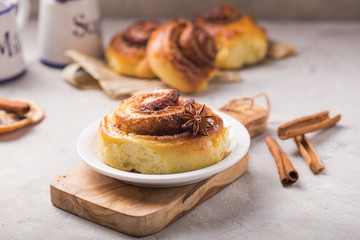 Confectionery baking. Sweet fresh soft roll bun with cinnamon on concrete background.  Christmas  food recipe