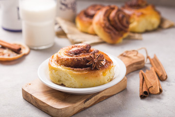 Confectionery baking. Sweet fresh soft roll bun with cinnamon on concrete background.  Christmas  food recipe