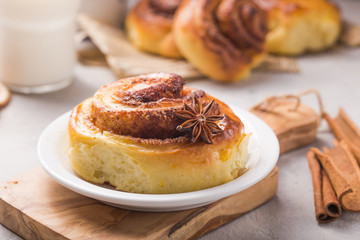 Confectionery baking. Sweet fresh soft roll bun with cinnamon on concrete background.  Christmas  food recipe