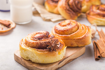 Confectionery baking. Sweet fresh soft roll bun with cinnamon on concrete background.  Christmas  food recipe