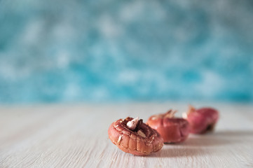Flat lay bulbs of gladioli on a blue background and copy space.