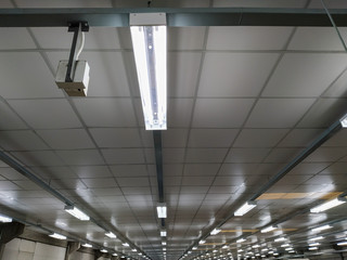 Long fluorescent light lamp under the ceiling In the building.