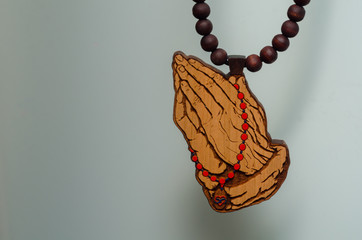 Wooden neckless. Praying hands
